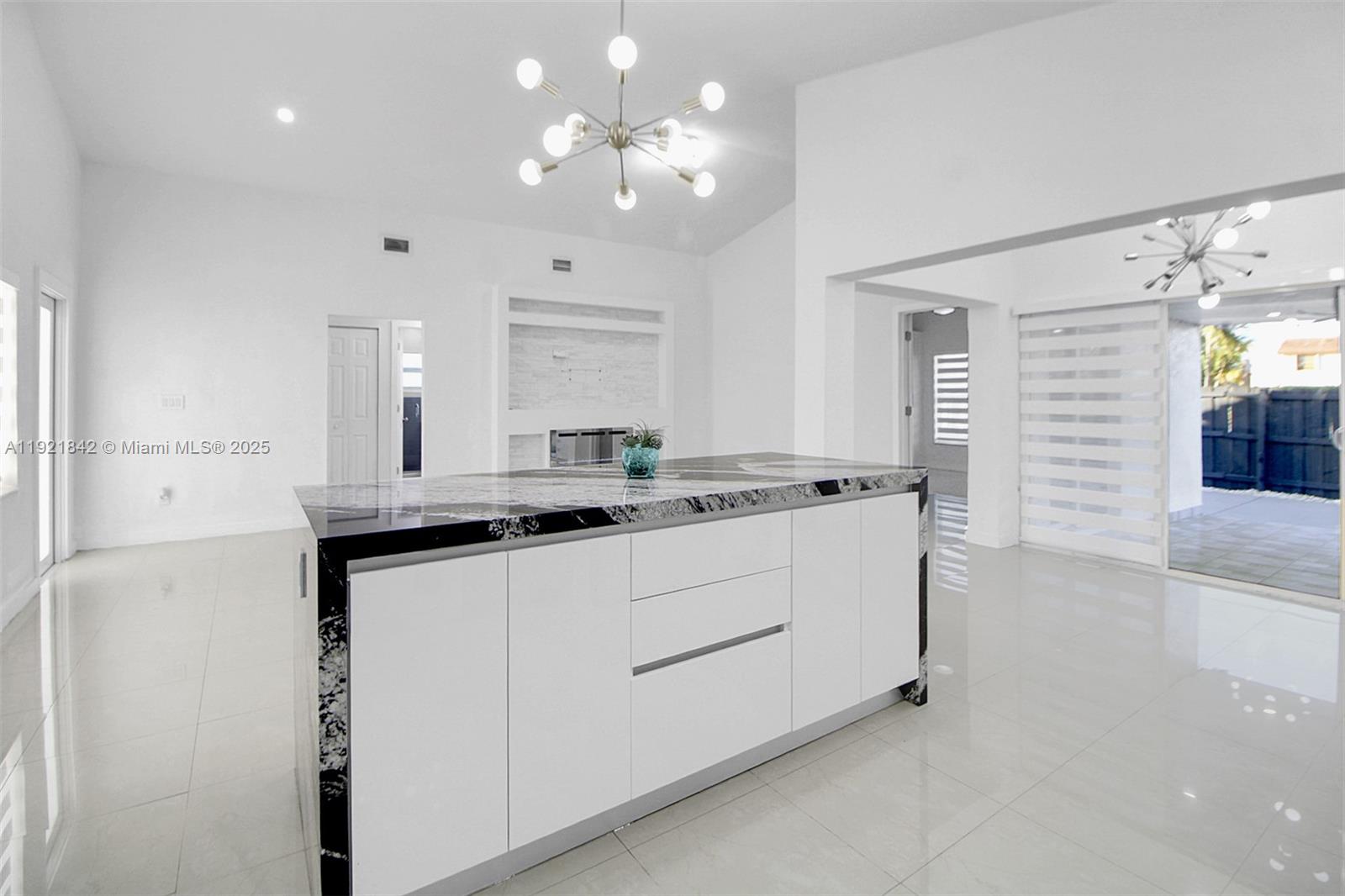 15251 Southwest 56th Terrace Miami, FL 33193 - Photo 5 of 29 a kitchen with kitchen island a sink stainless steel appliances and cabinets