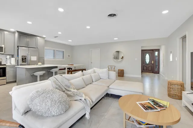 a living room with furniture kitchen and a table