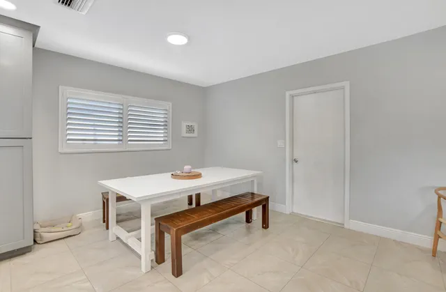 a room with a table and windows