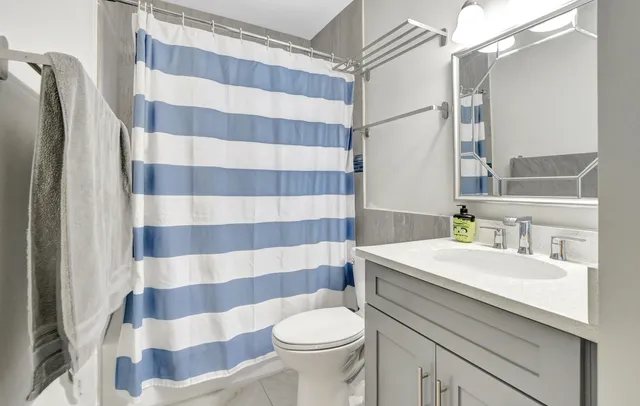 a bathroom with a sink toilet and shower