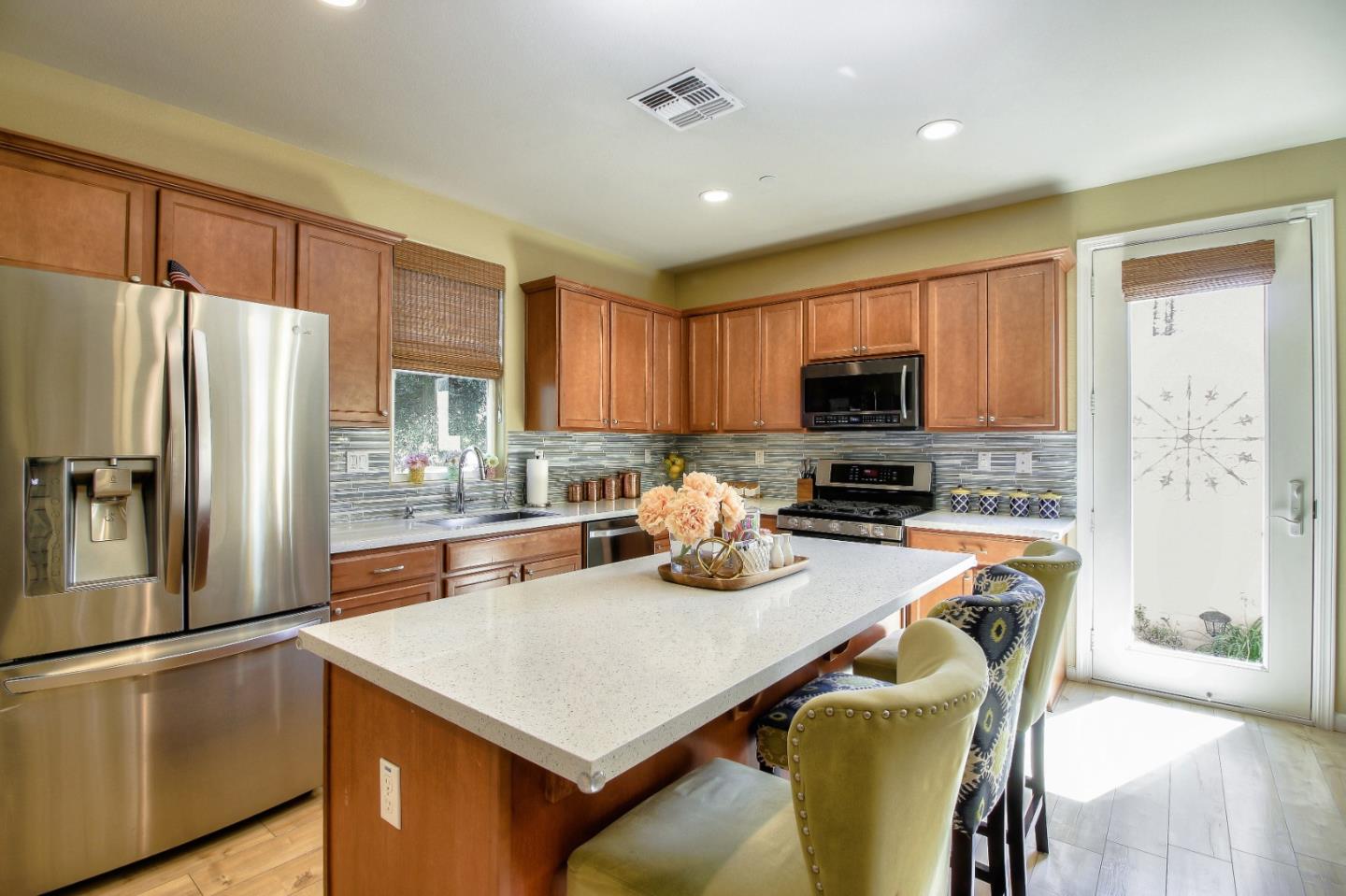 692 Gale Drive Campbell, CA 95008 - Photo 4 of 23 a kitchen with a refrigerator a stove top oven a sink and cabinets