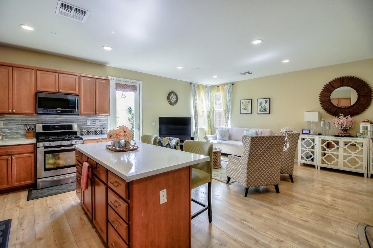 692 Gale Drive Campbell, CA 95008 - Photo 6 of 23 a kitchen with stainless steel appliances granite countertop a stove top oven a sink dishwasher a dining table and chairs with wooden floor