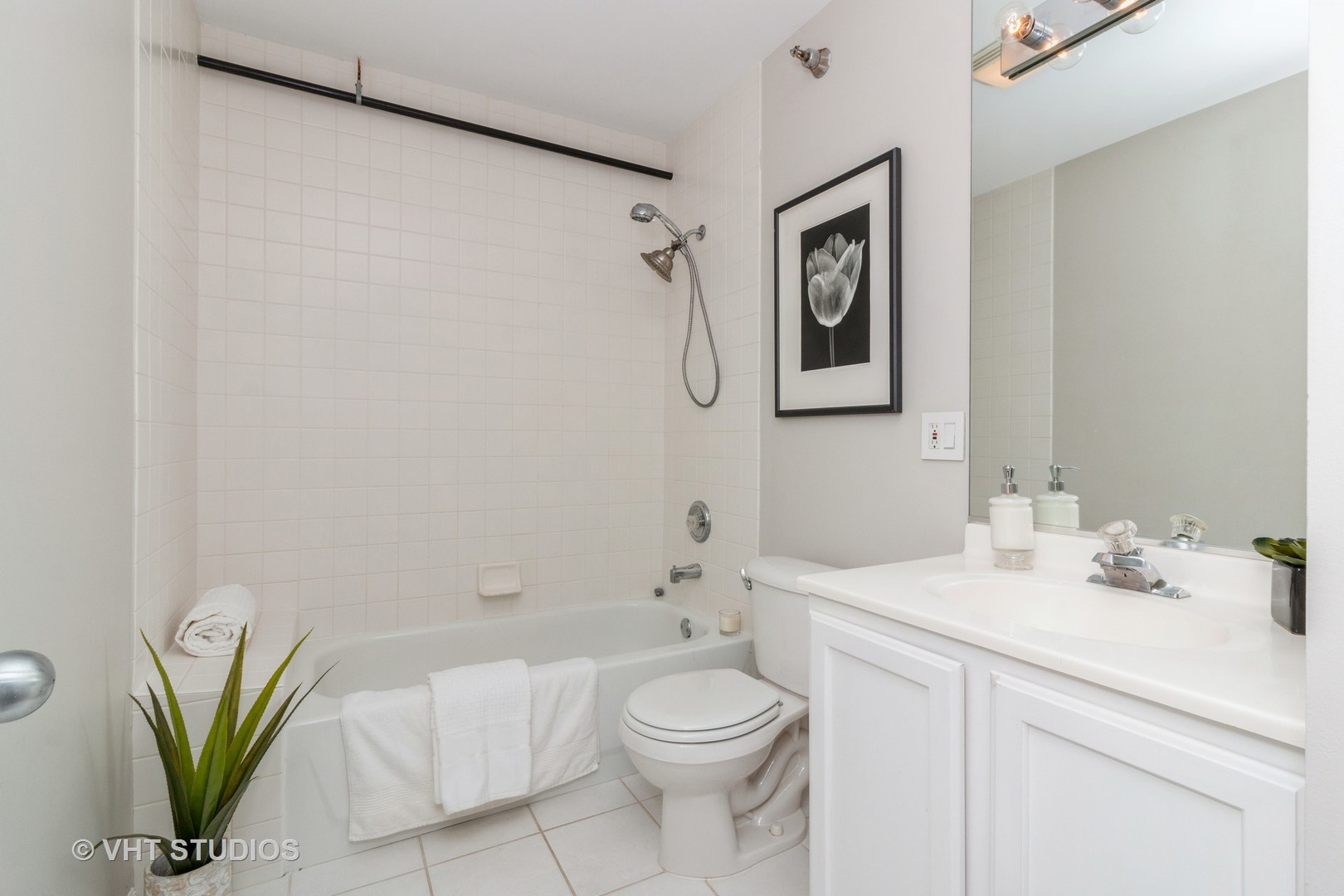 1830 Ridge Avenue, Unit 5C Evanston, IL 60201 - Photo 9 of 11 a bathroom with a toilet sink and a mirror