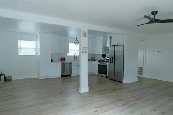a kitchen with a refrigerator and a sink
