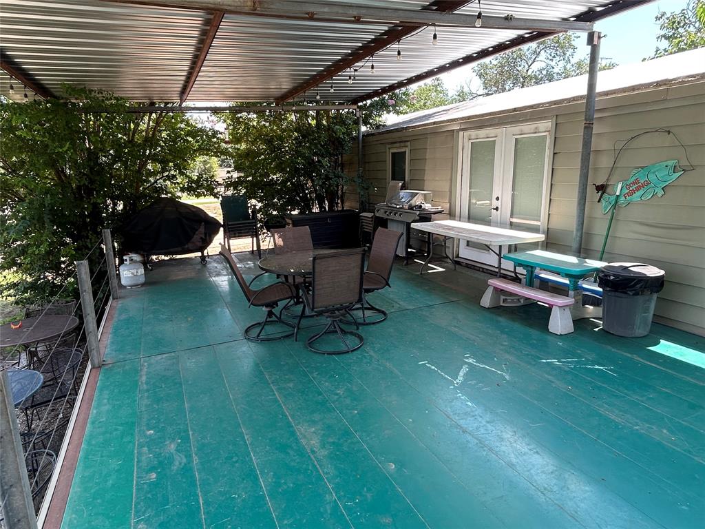 4705 Fox Hollow Road Graham, TX 76450 - Photo 6 of 28 View of patio / terrace with outdoor dining space, french doors, a deck, and area for grilling