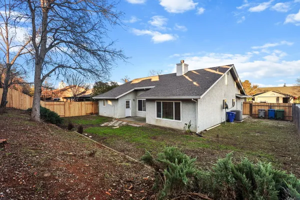a view of house with a yard