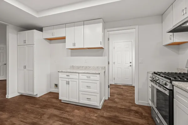 a kitchen with stainless steel appliances white cabinets and a stove