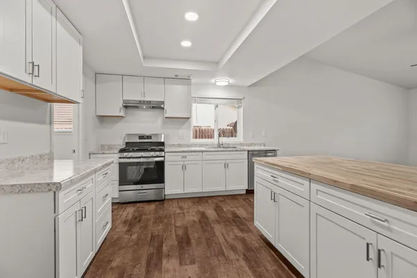 a kitchen with a stove top oven sink and cabinets