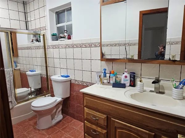 a bathroom with a sink toilet and mirror
