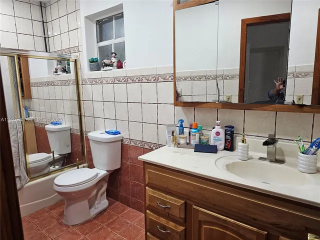 a bathroom with a sink toilet and mirror