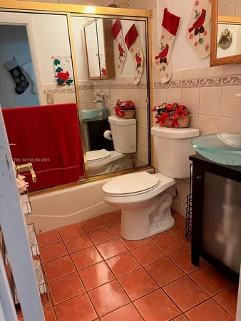 a bathroom with a toilet and a shower curtain