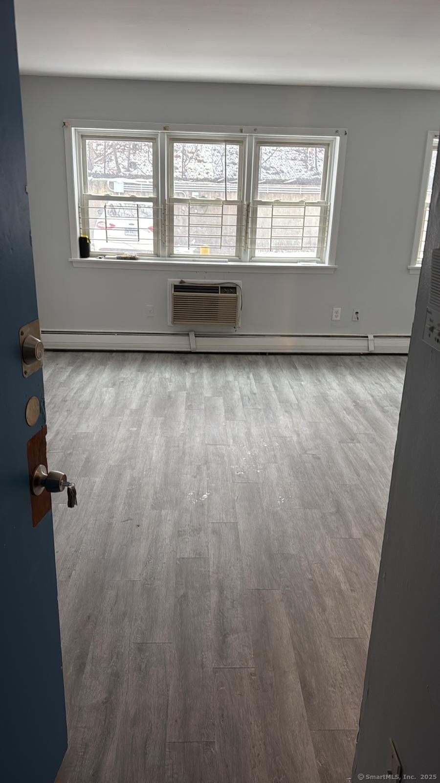 191 Oak Street Bridgeport, CT 06604 - Photo 2 of 7 wooden floor in an empty room with a window
