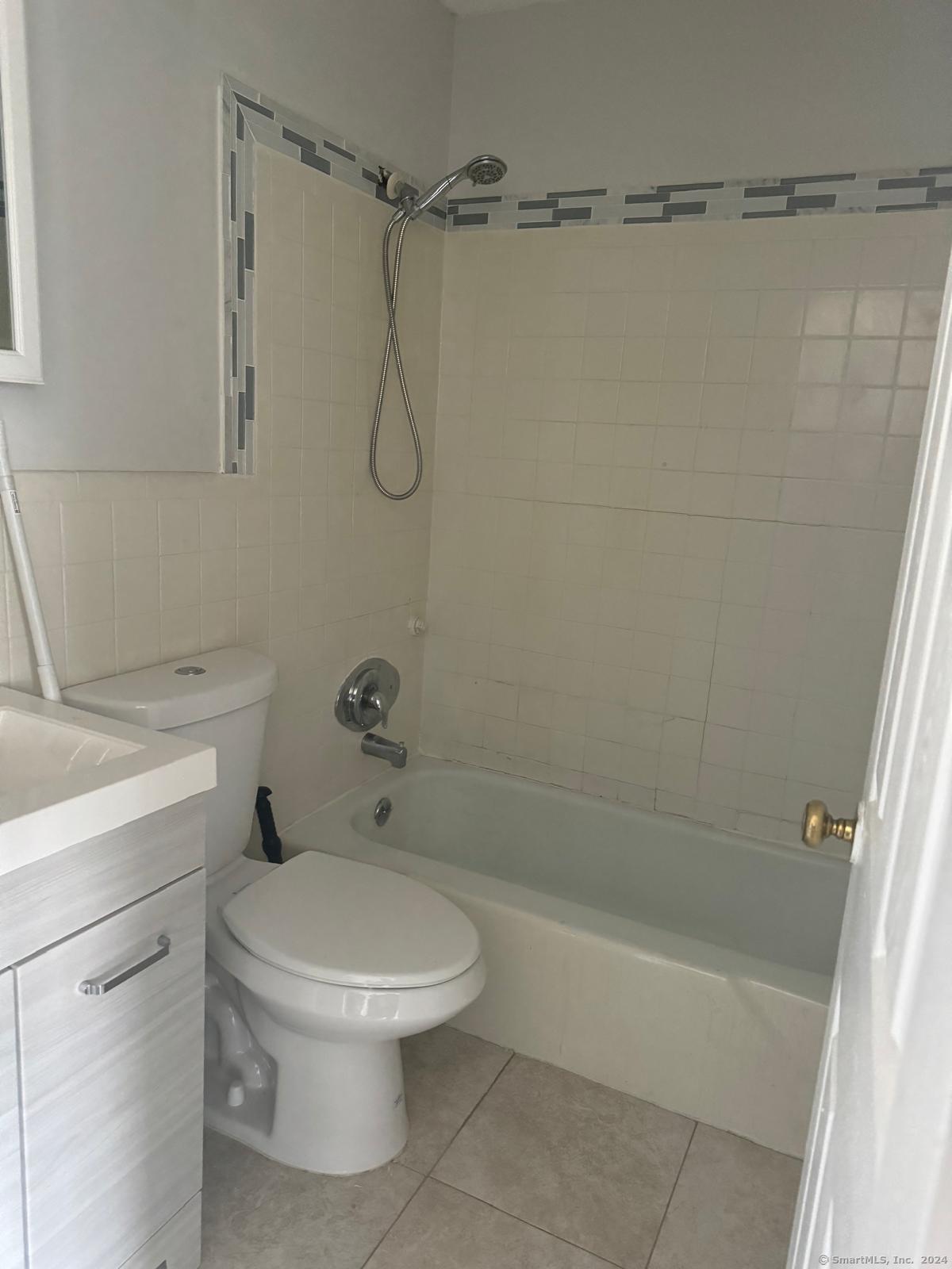 191 Oak Street Bridgeport, CT 06604 - Photo 3 of 7 a white toilet sitting next to a bath tub