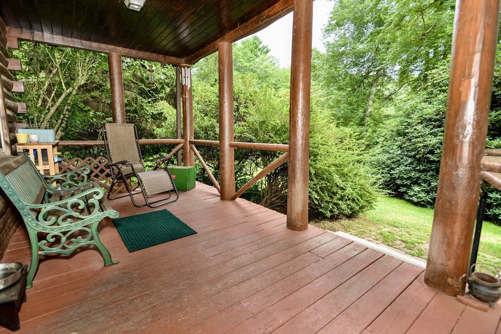 128 Danforth Street Rehoboth, MA 02769 - Photo 5 of 39 a view of a patio with table and chairs potted plants with wooden floor and fence