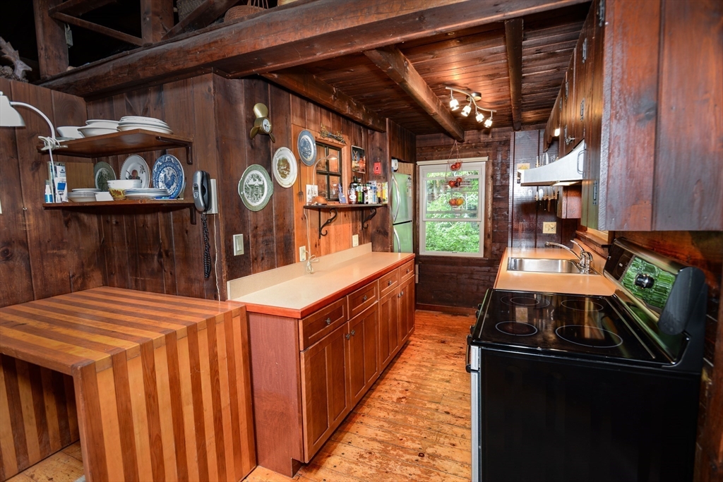 128 Danforth Street Rehoboth, MA 02769 - Photo 8 of 39 a kitchen with stainless steel appliances granite countertop a stove a sink and a microwave