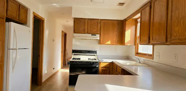 a kitchen with stainless steel appliances a stove a sink and a refrigerator