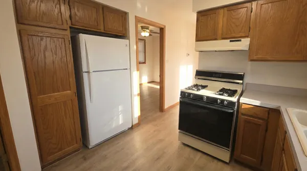 a kitchen with a refrigerator stove and cabinets