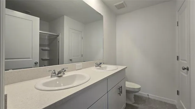 a bathroom with a sink toilet and mirror