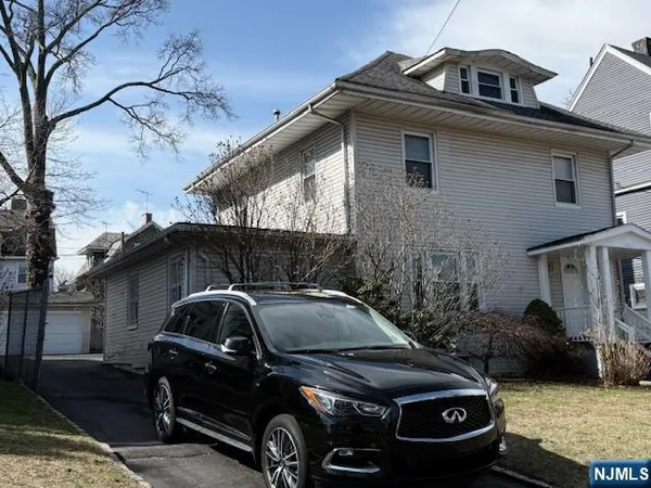a front view of a house with parking space