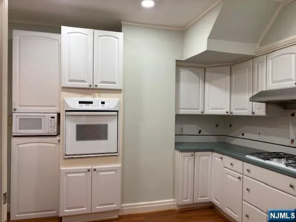 a kitchen with stainless steel appliances granite countertop a refrigerator and a stove