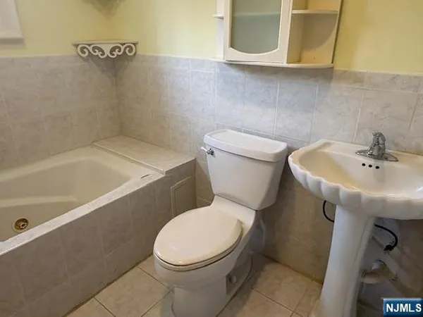 a white toilet sitting next to a bathroom sink