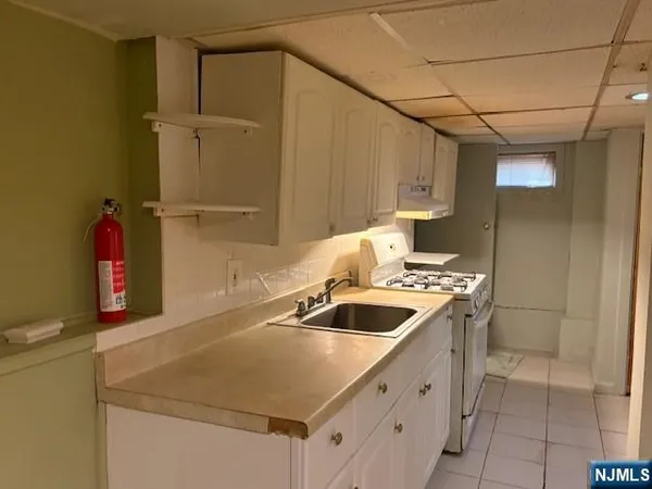 a kitchen that has a sink and a stove
