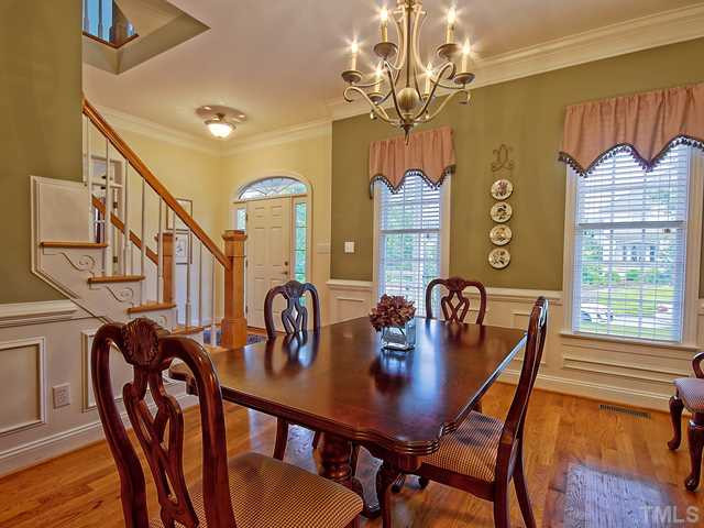 1812 Stannard Trail Raleigh, NC 27612 - Photo 3 of 25 The dining room is open to the foyer and offers beautiful hardwood floors, crown molding and wainscoting. Dining Room