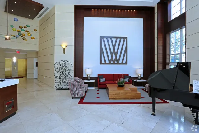 a living room with fireplace furniture and floor to ceiling windows