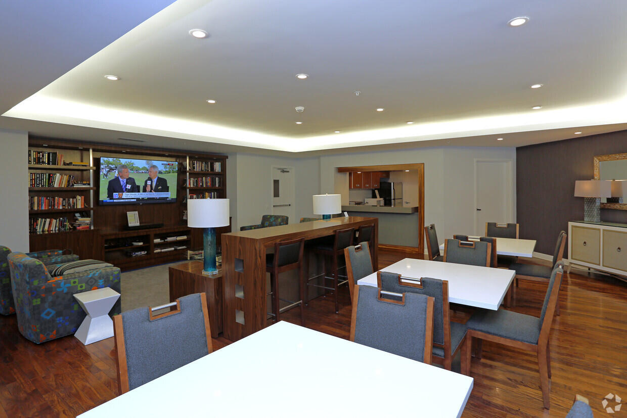 410 Evernia Street, Unit 519 West Palm Beach, FL 33401 - Photo 25 of 27 a living room with stainless steel appliances furniture a rug and a kitchen view