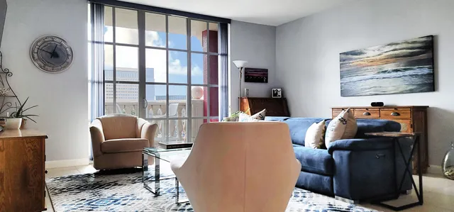 a living room with furniture a couch and wooden floor