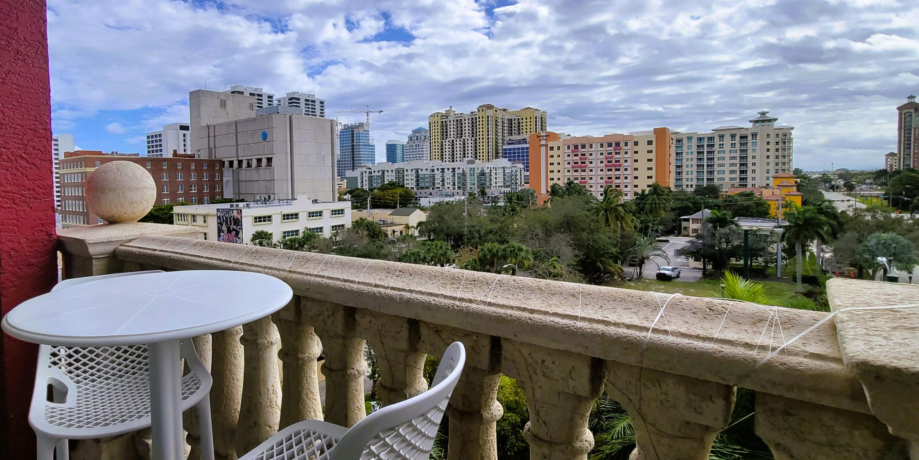 410 Evernia Street, Unit 519 West Palm Beach, FL 33401 - Photo 10 of 27 a view of a balcony with a table and chairs