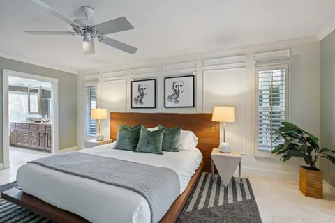 a bedroom with a bed and a chandelier