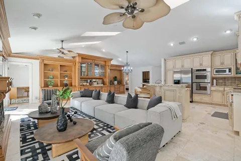 a living room with furniture kitchen and a table