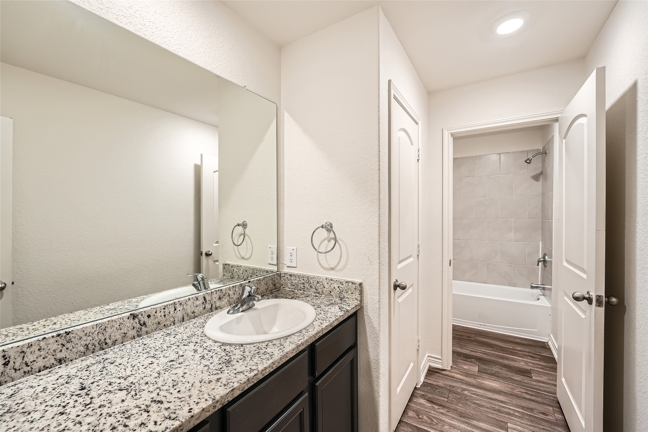 14513 Prairie Sod Lane Elgin, TX 78621 - Photo 26 of 36 a bathroom with a granite countertop sink a mirror and a shower