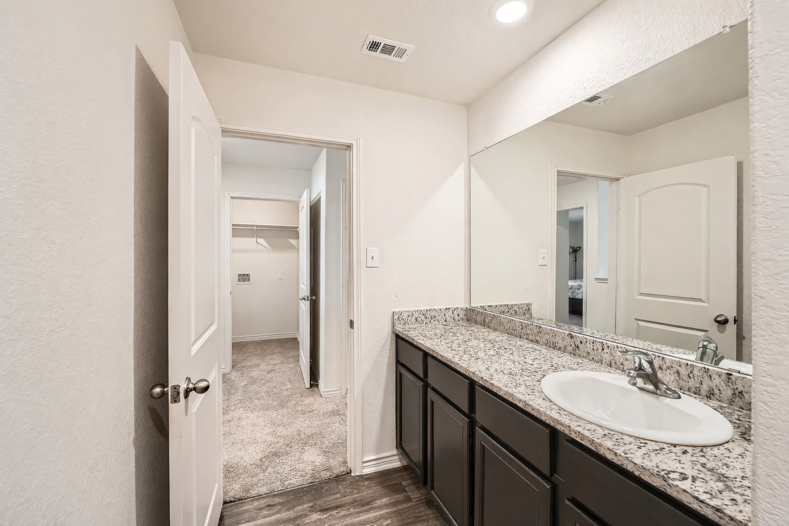 14513 Prairie Sod Lane Elgin, TX 78621 - Photo 27 of 36 a bathroom with a granite countertop sink and a mirror