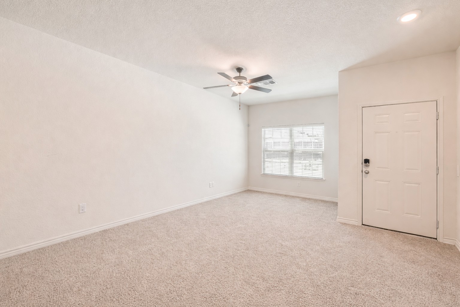 14513 Prairie Sod Lane Elgin, TX 78621 - Photo 3 of 36 an empty room with windows and fan
