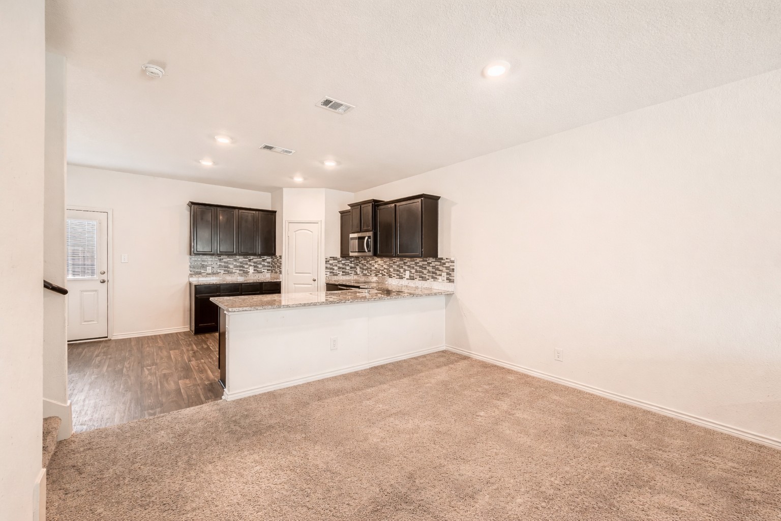 14513 Prairie Sod Lane Elgin, TX 78621 - Photo 9 of 36 a view of a kitchen with refrigerator stove microwave and cabinets