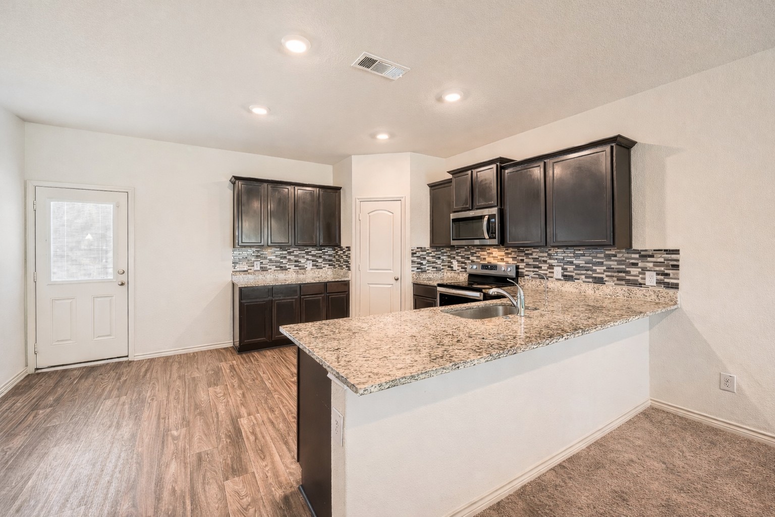14513 Prairie Sod Lane Elgin, TX 78621 - Photo 10 of 36 a kitchen with a sink and a refrigerator