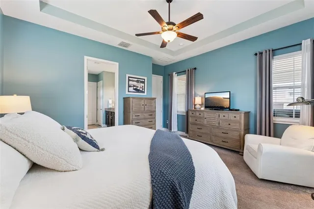 a bedroom with a bed a couch and a television