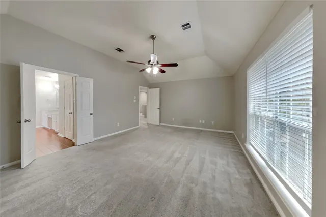 a view of a livingroom with a ceiling fan and window