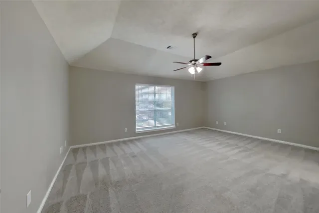 a view of a room with window and ceiling fan
