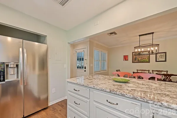 a bedroom with granite countertop a sink and a walk in closet
