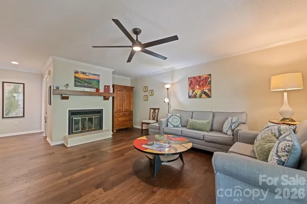 a living room with furniture a fireplace and a flat screen tv