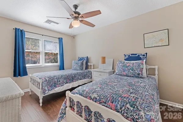 a bedroom with two beds and a large window