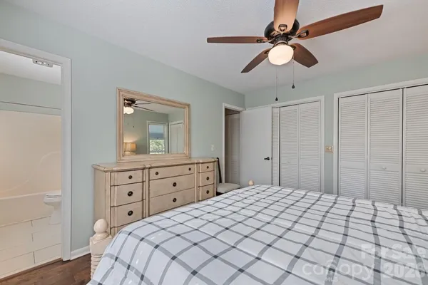 a bedroom with a large bed and a chandelier