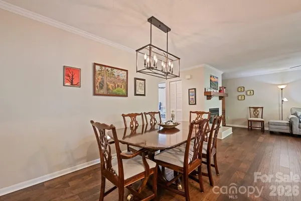 a view of a dining room with furniture wooden floor and a chandelier