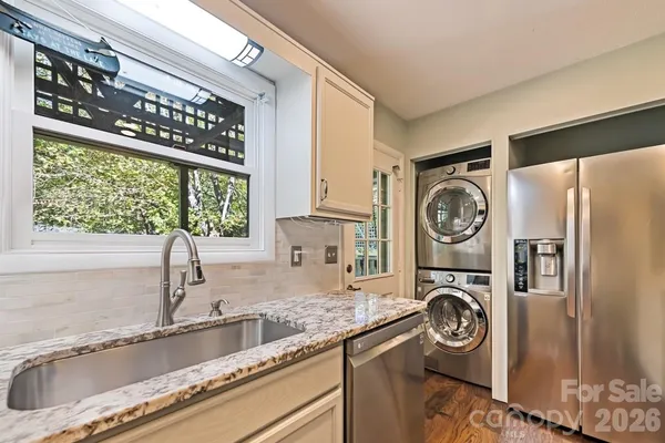 a kitchen with a refrigerator and a sink