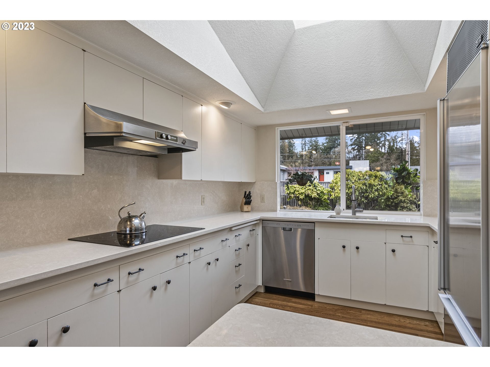 2217 Cascade Way Longview, WA 98632 - Photo 11 of 32 a kitchen with granite countertop a sink window and cabinets