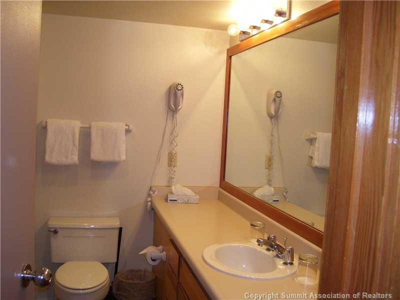 22340 Highway 6, Unit 1815 Keystone, CO 80435 - Photo 11 of 12 a bathroom with a sink a toilet and a mirror