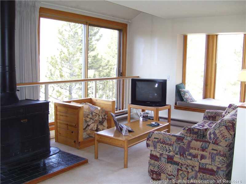 22340 Highway 6, Unit 1815 Keystone, CO 80435 - Photo 3 of 12 a living room with furniture and a flat screen tv